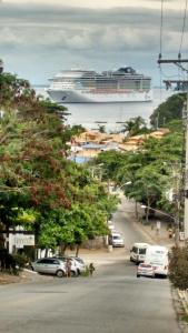 a cruise ship in the water with cars parked at Pousada Portico de Buzios in Armacao dos Buzios