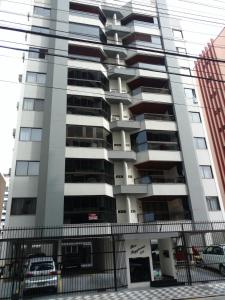 a tall apartment building with a fence in front of it at Apto 3 quartos 103m² in Itapema