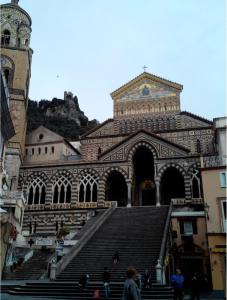 a large building with stairs in front of a building at Casa Duomo in Amalfi