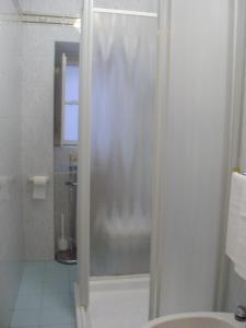 a shower with a glass door in a bathroom at Albergo Anna in Perugia