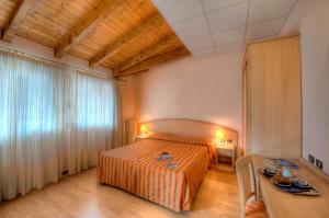 Postel nebo postele na pokoji v ubytování Hotel Residence Dei Fiori