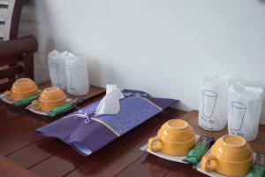a wooden table with two plates of food on it at Mountain View House in Sangkhla Buri