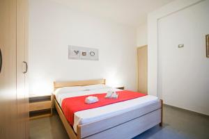 a bedroom with a bed with a red blanket at Gaeta apartament in Gaeta