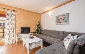 a living room with a couch and a christmas tree at Apartment Vila Lokve in Lokve
