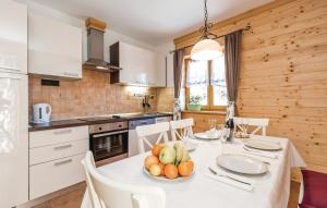 a kitchen with a table with a bowl of fruit on it at Apartment Vila Lokve in Lokve