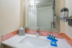 a bathroom with a sink and a mirror at Holiday Inn Express & Suites Nassau by IHG in Nassau