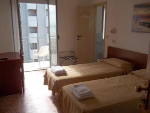 Ένα ή περισσότερα κρεβάτια σε δωμάτιο στο Hotel Italia