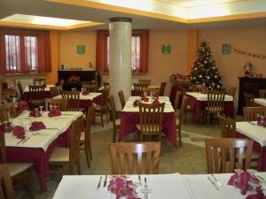 ein Esszimmer mit Tischen und einem Weihnachtsbaum in der Unterkunft Albergo Corradetti in Castel di Sangro