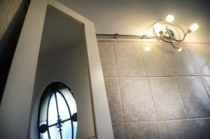 a bathroom with a mirror and a window and a light at Casa Mutante Hostel in Montevideo +25 photos