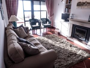 a living room with a couch and a fireplace at Ericeira Sea View - Mar à Vista in Ericeira