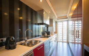 a kitchen with a sink and a counter top at Gava Beach 1st Line in Gavà