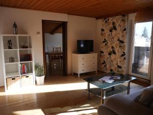 a living room with a couch and a table at Ferienwohnung Holiday Lienz in Lienz