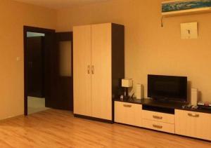 a living room with a television and a cabinet at Sirena Appartment in Sveti Vlas