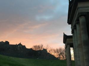 a view of a castle at sunset at Drummond Apartment in Edinburgh