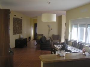 a living room with a couch and a table at Moradia Rossio,11 in Odeceixe
