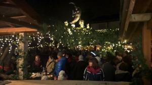 a crowd of people sitting in a room with lights at Gasthof Ulrich Meyer in Landshut