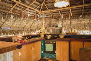 a kitchen with a stove and a counter top at Fare Ahuna in Bora Bora