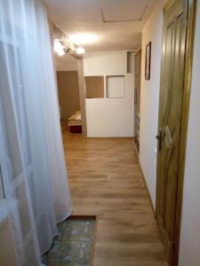 a corridor of a room with a door and curtains at Sadyba Lesivykh in Slavske