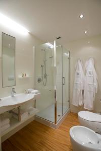 een badkamer met een douche, een wastafel en een toilet bij Hotel Napoleon in Cherasco