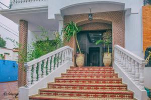 a staircase leading to a house with potted plants at Casa Familia in Chefchaouen