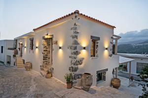 a white building with lights on the side of it at Patriko House in Plakias