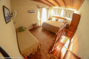 a bedroom with a bed and a staircase in a room at De Luna in Puerto Pirámides