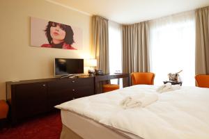 A bed or beds in a room at Hotel Bystrá