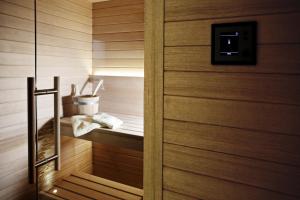 a bathroom with a sauna with a wooden door at Villa Sofia & Spa in Gaiole in Chianti