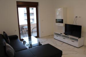 a living room with a couch and a flat screen tv at Casa Rados Fazana in Fažana