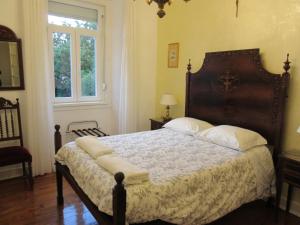a bedroom with a large bed with white pillows at Family Macedo in Lisbon