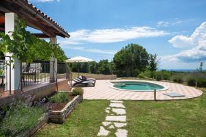 a backyard with a swimming pool and a house at Villa Valmont in Labin