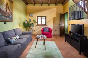 a living room with a couch and a tv at Villa Valmont in Labin