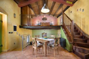 a dining room with a table and a staircase at Villa Valmont in Labin