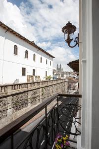a balcony with a view of a city at Hotel Colonial San Agustin in Quito