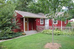 a red house with a tree in the yard at Phoenicia Lodge in Phoenicia