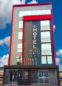 a building with a sign that reads palmas needles at Hotel Palmas Reales in Trujillo