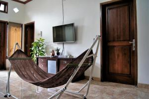 a hammock in a living room with a tv at Villa Cabean Salatiga in Salatiga