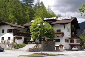 a building with solar panels on top of it at Haus Acherkogel in Tumpen