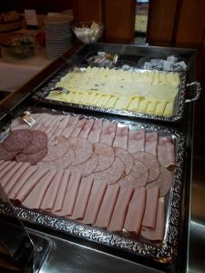 two trays of meats and cheese on a table at Jugendgästehaus St. Gilgen in Sankt Gilgen