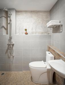 a bathroom with a white toilet and a sink at The Step Chiang Mai in Chiang Mai +32 photos