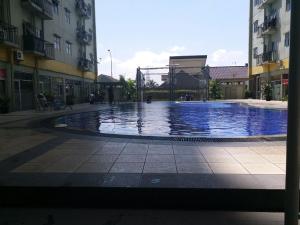 a large swimming pool in the middle of a building at Suites Metro Bandung - Aloha in Bandung