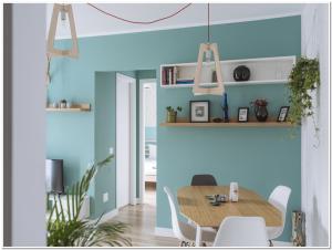 a dining room with blue walls and a table and chairs at Spacious, lovely, bright apartment in the Old Town in Bucharest