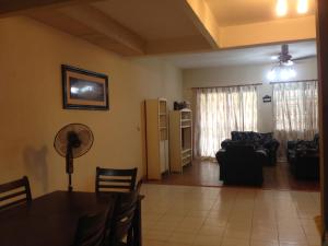 a living room with a table and a couch at Aziym Homestay@Bandar Baru Bangi in Kampong Tangkas