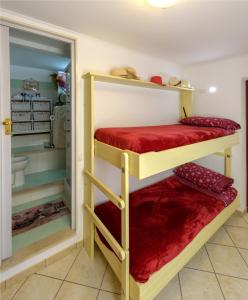 a bathroom with two bunk beds in a room at Il Giardino dei Gigli in Meta