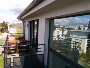 a balcony with chairs and a view of a city at Rooftop Luxembourg Ville in Luxembourg
