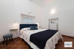 a bedroom with a bed and a chair in it at La Suite 48 in Vietri sul Mare