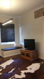 a living room with a flat screen tv and a couch at Capel Short-Stay Accommodation in Capel