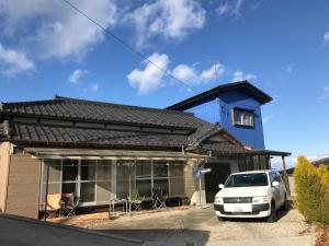 a white car parked in front of a house at Traveler's Wharf Shichigahama in Shichigahama