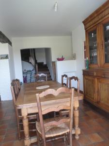 una sala da pranzo con tavolo e sedie in legno di Entre mer montagne Béarn et Pays Basque a Orthez