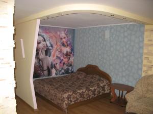 En eller flere senge i et værelse på Уютная квартира ФЕНТЕЗИ